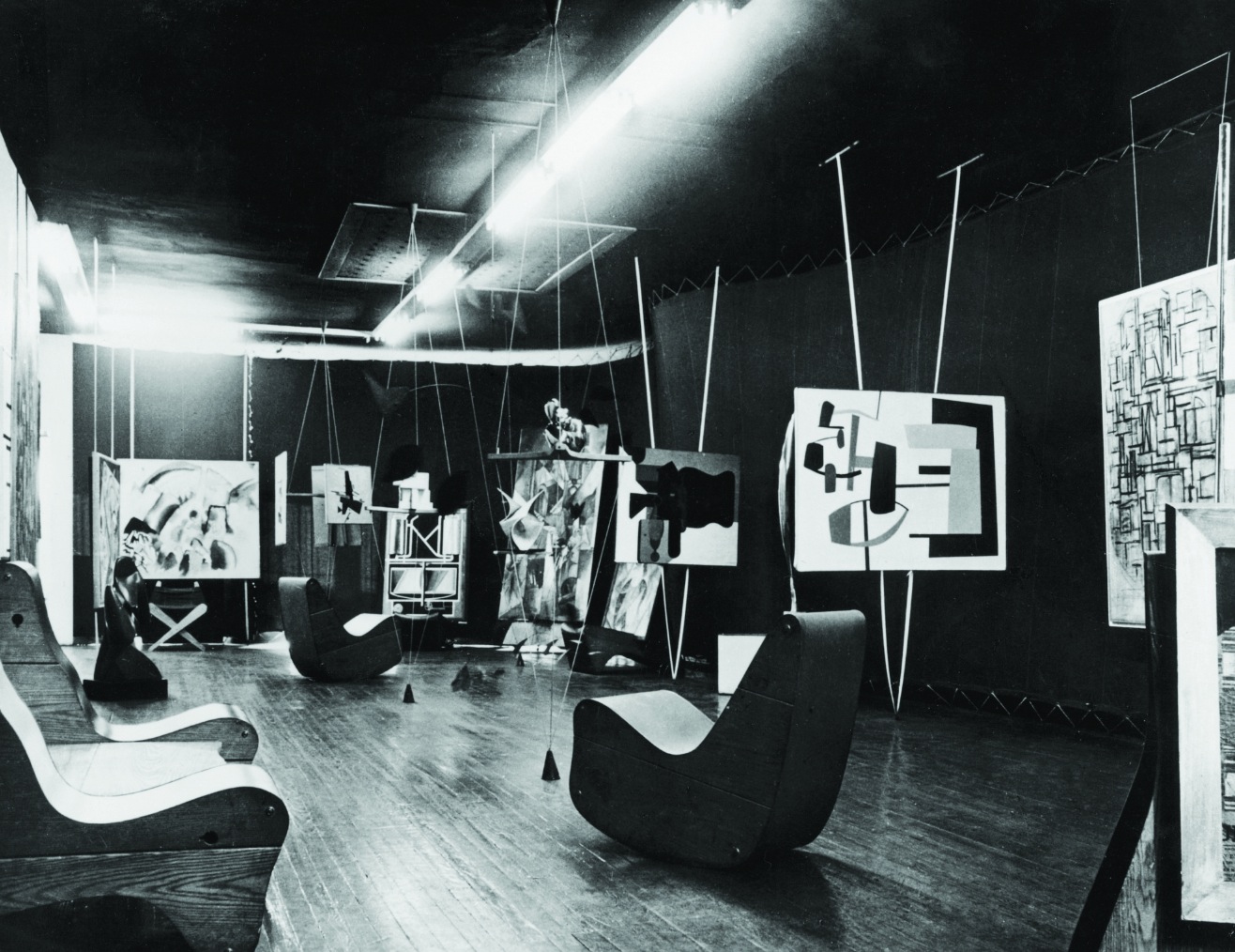 The Abstract Gallery of Art of This Century, New York, 1942, Peggy Guggenheim’s gallery designed by Frederick Kiesler.  Background, left: Vasily Kandinsky, Landscape with Red Spots, No. 2 (1913, Peggy Guggenheim Collection); foreground, right: Jean Hélion, Equilibrio (1933, Peggy Guggenheim Collection) Courtesy Solomon R. Guggenheim Foundation