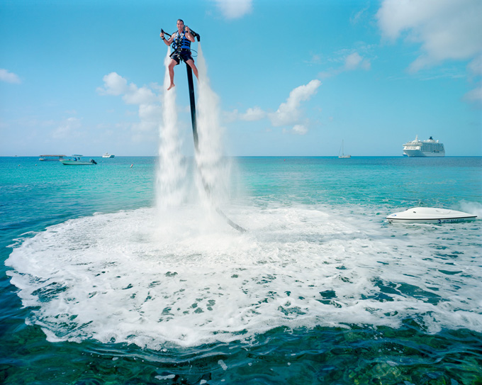 An employee of “Jetpack Cayman” demonstrates this new watersport, now available on the island.  © Paolo Woods-Gabriele Galimberti. The Heavens-COTM