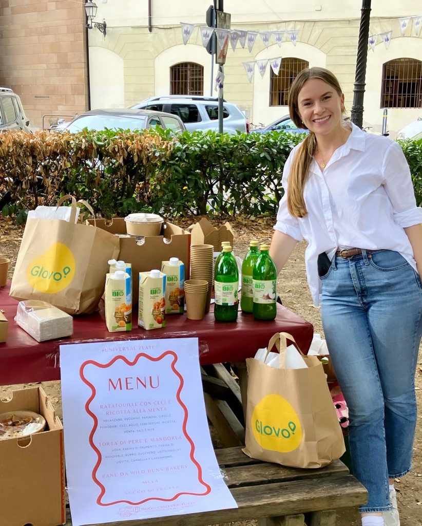Ellie, a Buon Cibo member, serving at the food stand in piazza Tasso
